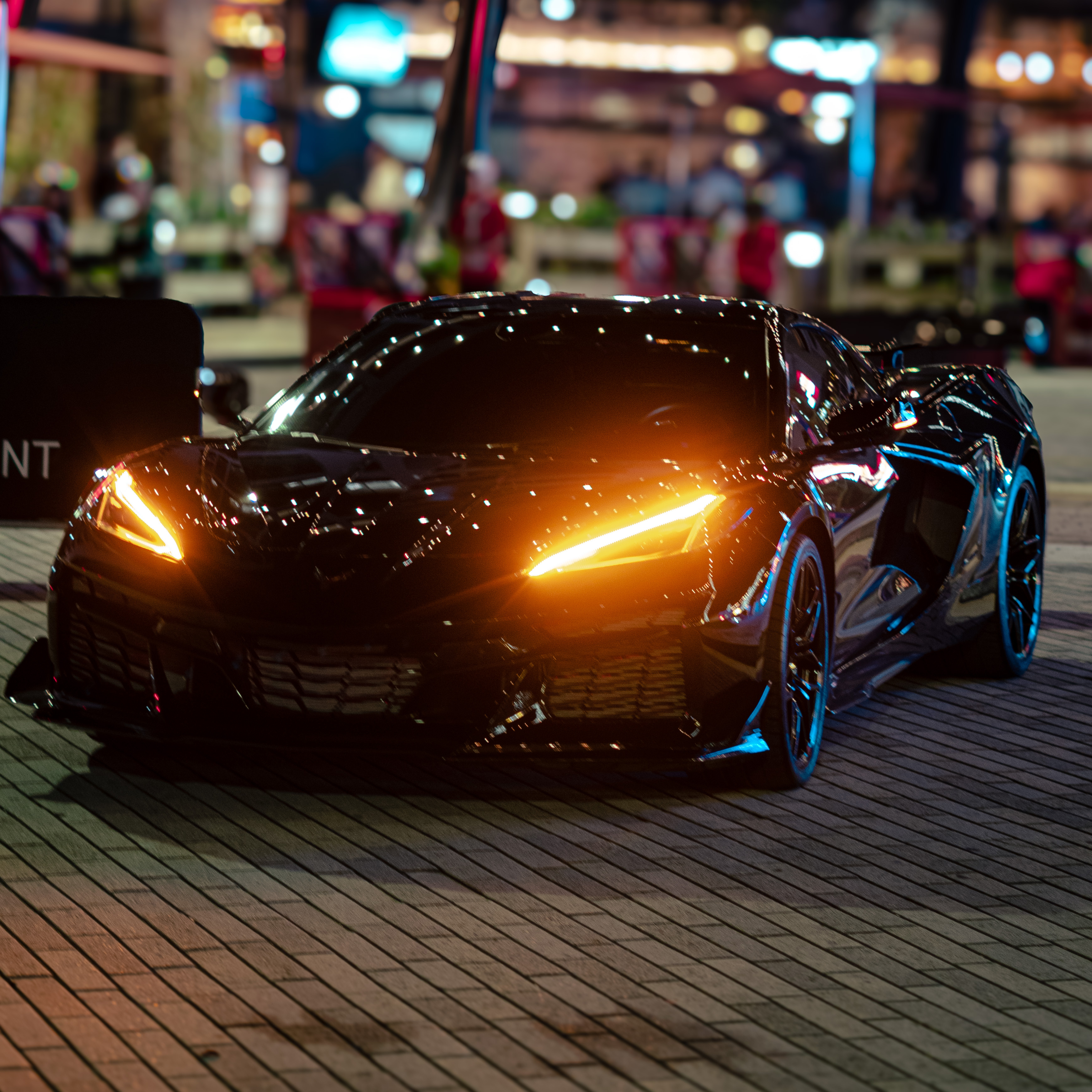 Corvette at night with glowing headlights after detail